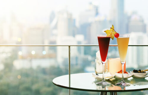 Upscale Living and Elevated Lifestyles - cocktails on a table at the rooftop lounge with expansive views